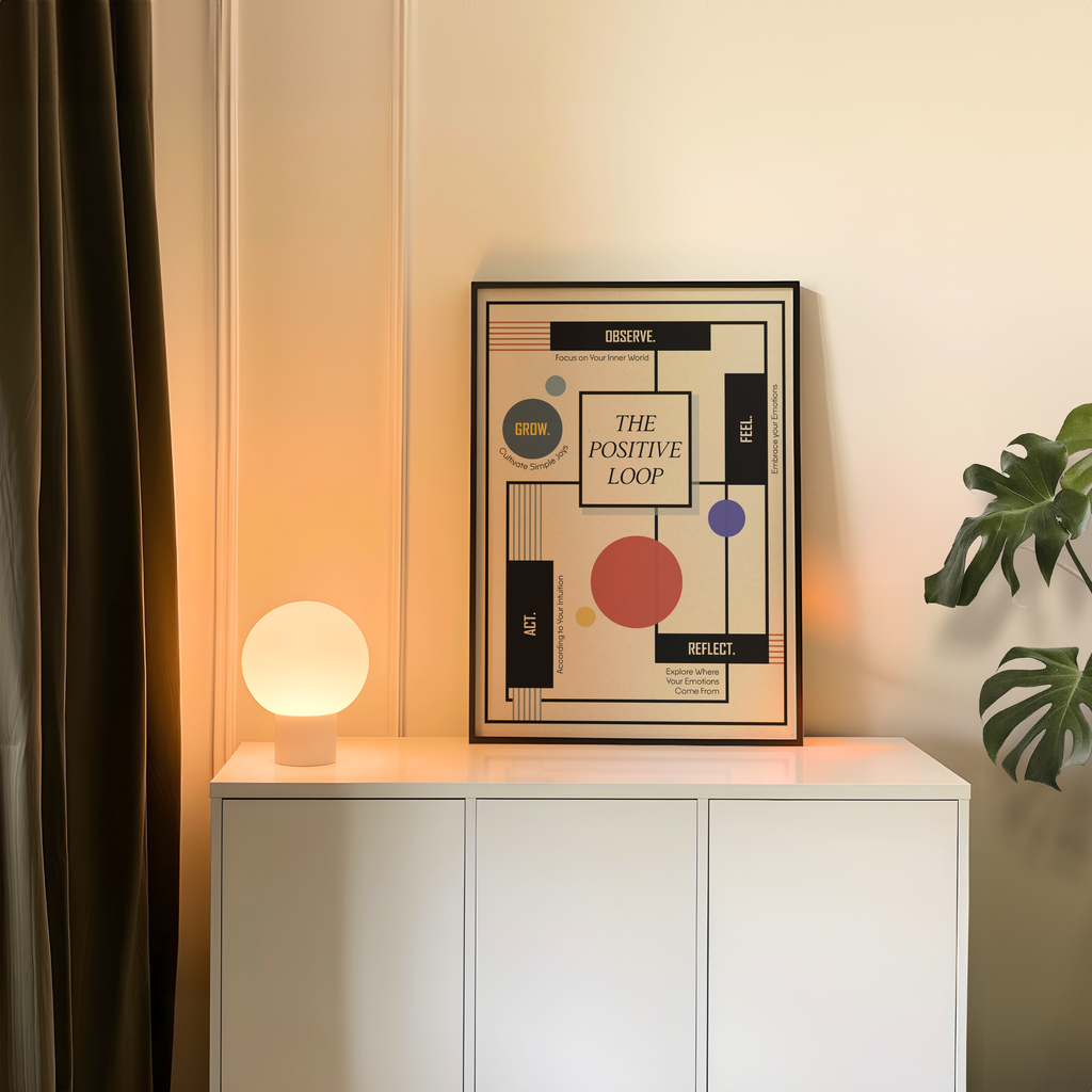 A framed Bauhaus-inspired geometric healing art print titled "The Positive Loop" styled on a white cabinet in a contemporary living room. Modern mental health wall art for therapy office decor, therapist and psychologist offices, counseling rooms, wellness clinics, coaching spaces, and mindful home interiors.