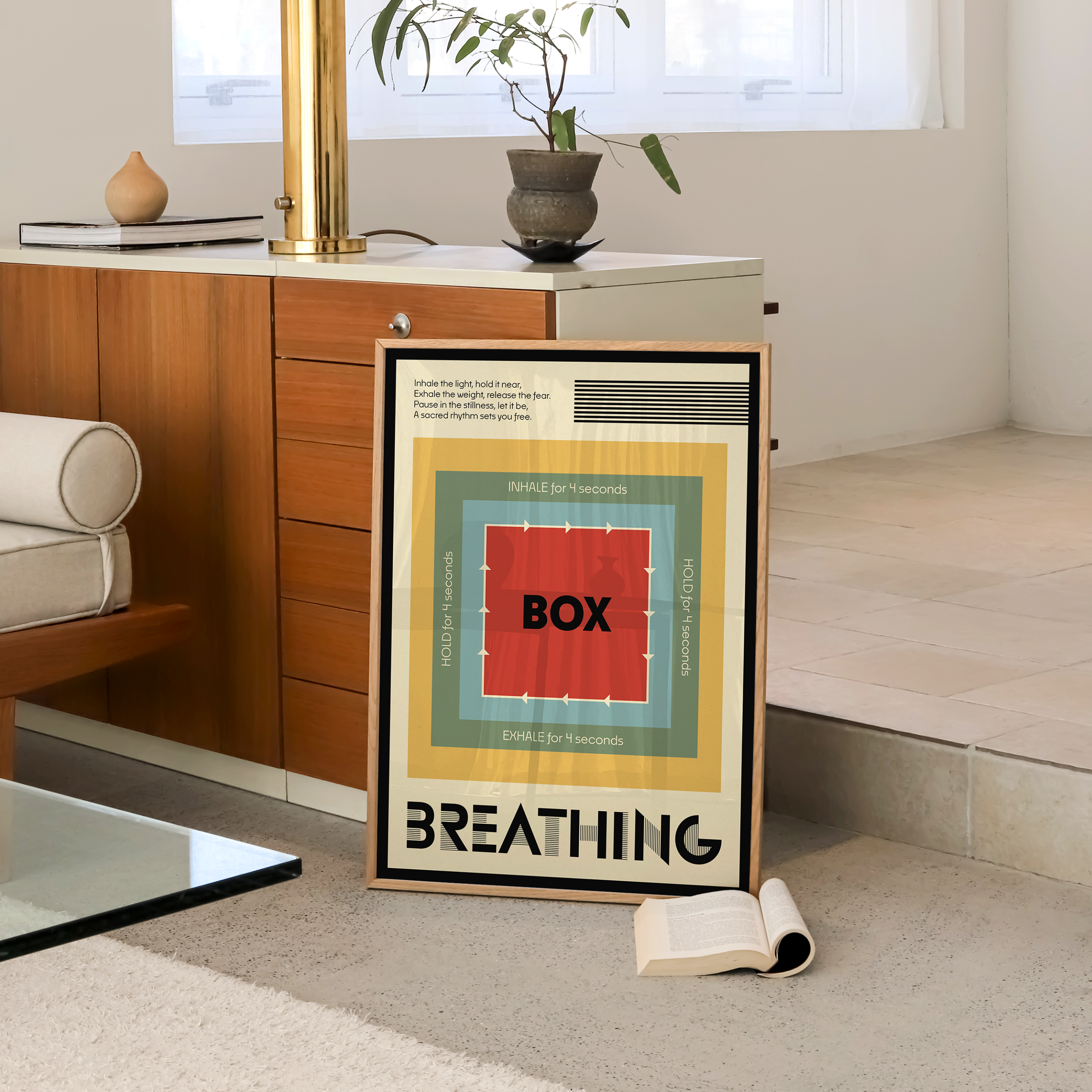A framed art print featuring a colorful geometric 'Box Breathing' diagram, styled in a modern living room setting next to a wooden cabinet.