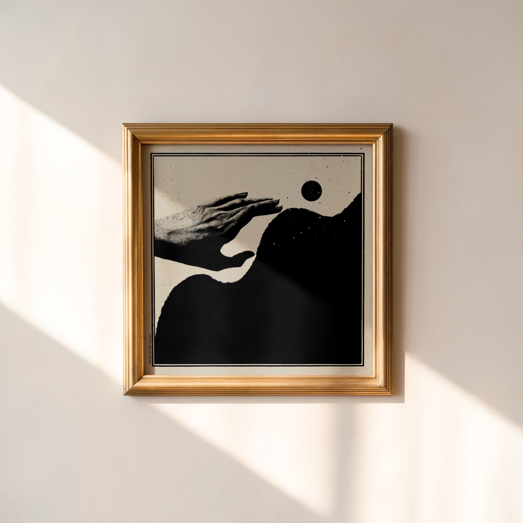 Framed Momentum abstract art print with a black and beige illustration of an outstretched hand reaching above abstract organic forms beneath a black moon. Displayed on a beige wall with soft diagonal sunlight, this minimalist monochrome wall decor suits modern, Japandi, Scandinavian, and contemporary interiors.